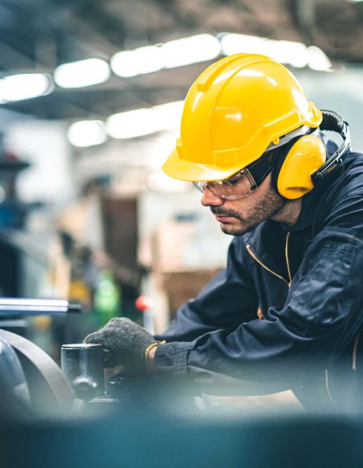 Industrial Engineers in Hard Hats.Work at the Heavy Industry Manufacturing Factory.industrial worker indoors in factory. man working in an industrial factory.Safety first concept.